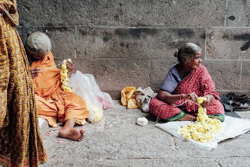 Women selling flowers outside a temple