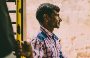 Man holding train handle