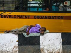 Man lying on footpath, Homeless