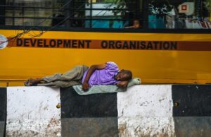 Man lying on footpath, Homeless